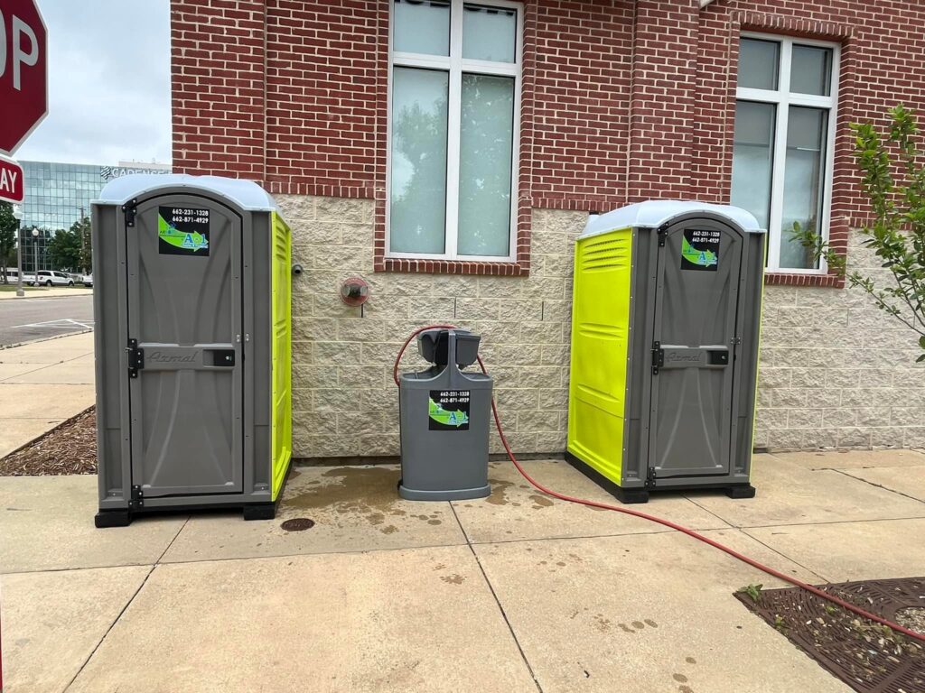 Hand wash station between two porta potties